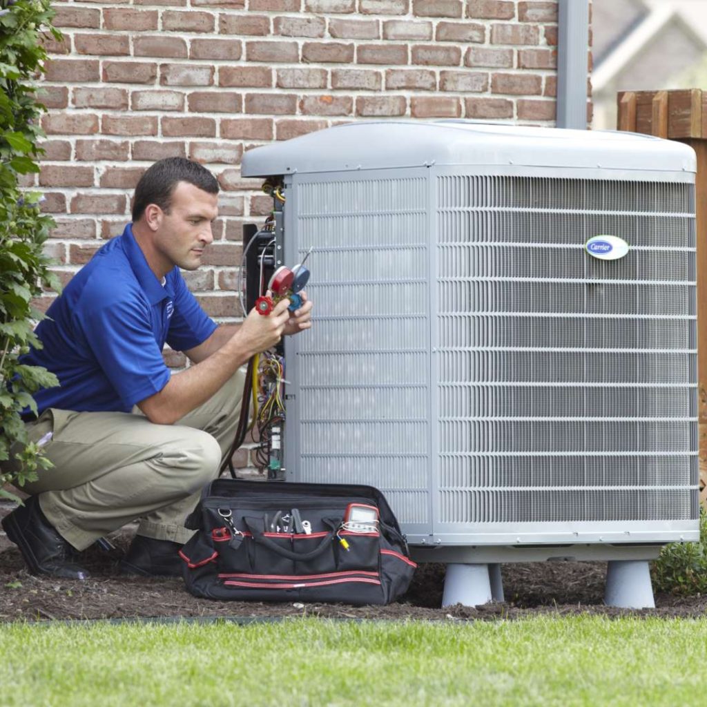 Sandium HVAC technician servicing AC unit in a Mountain View, CA home