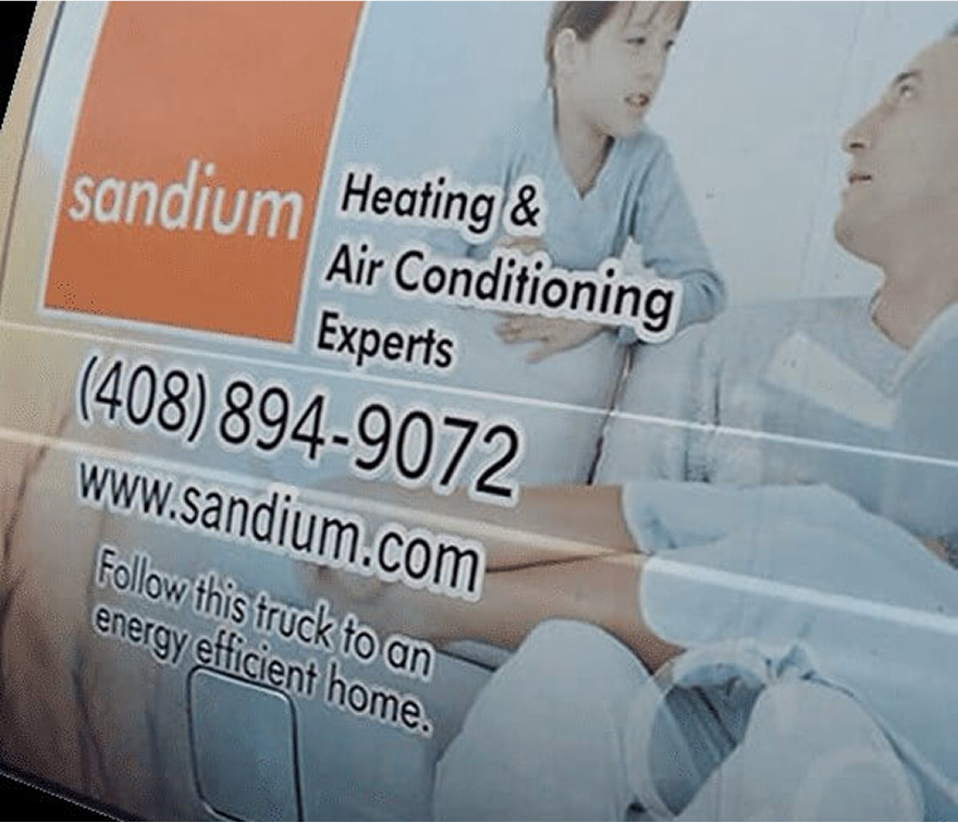 Sandium HVAC technician servicing AC unit in a Campbell, CA home