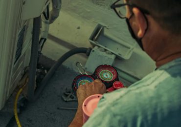 Sandium technician removing old AC unit before installing new system in San Jose, CA